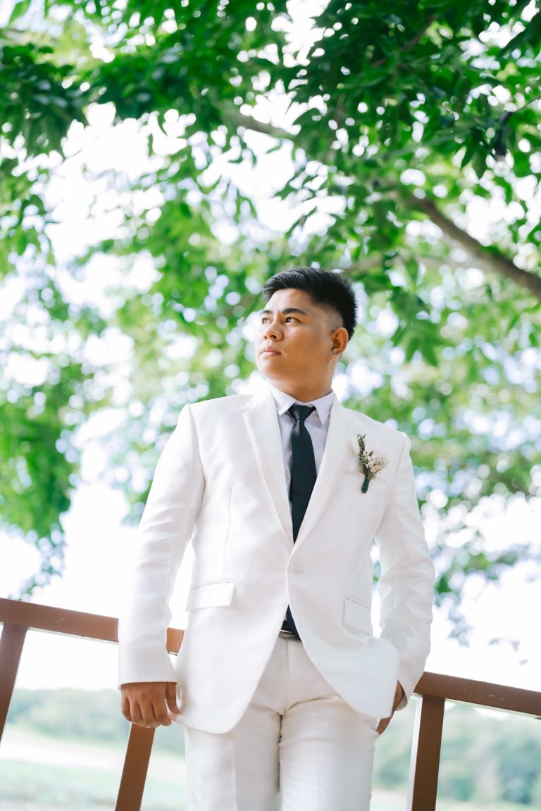 Jerry Espanueva Jr in a white tuxedo.